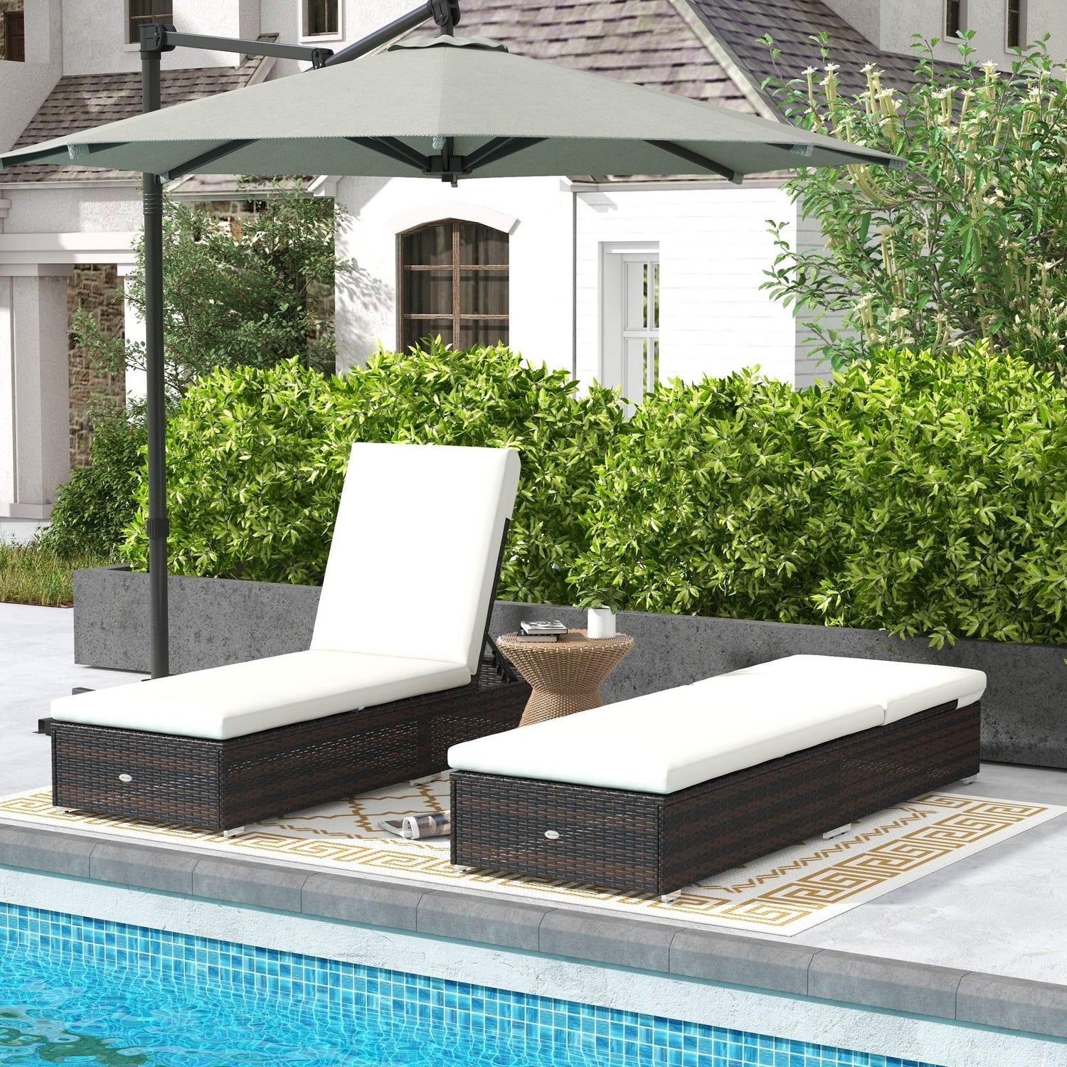 Set of two adjustable rattan sun loungers with cream padded seats, dark brown frame